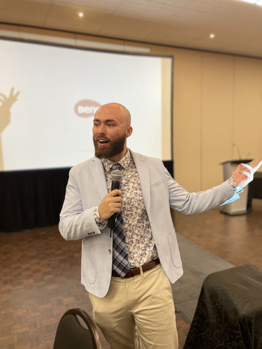 Joshua Grootenboer speaking on stage at an industry event